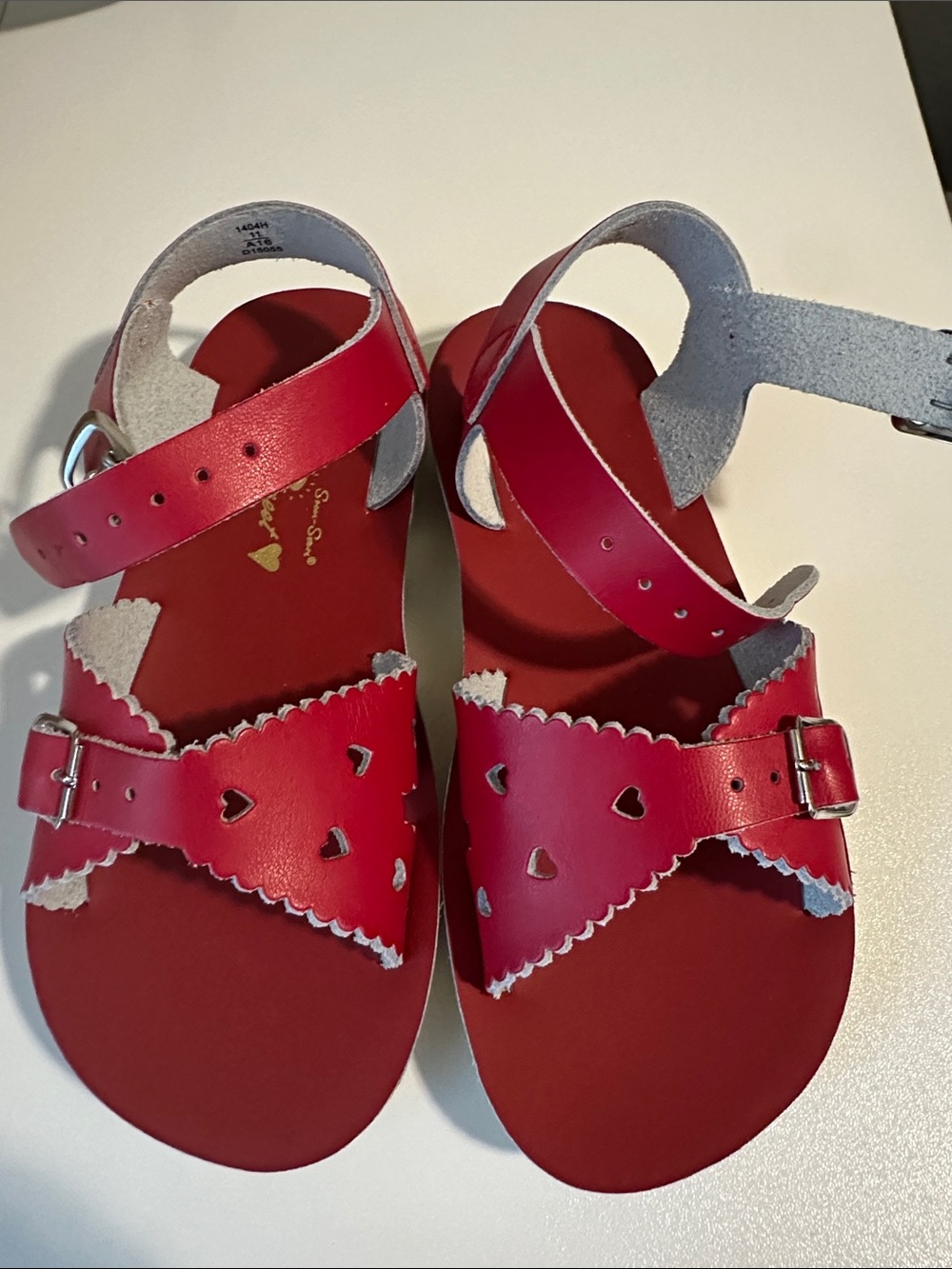 Sun-San Sweetheart sandals in red leather, featuring heart-shaped cutouts and a